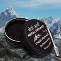 ShilNepal Nepal Shilajit container with a spoon and with a mountainous background