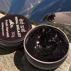 Nepal Shilajit container with shilajit and a spoon on a mountain background